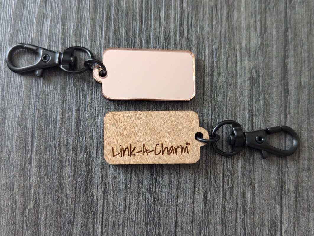 Rose gold acrylic and engraved wood Link-A-Charm bag tags with black lobster clasps